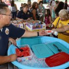 A Lemoore VIP passes out watermelon at Tuesday's National Night Out.